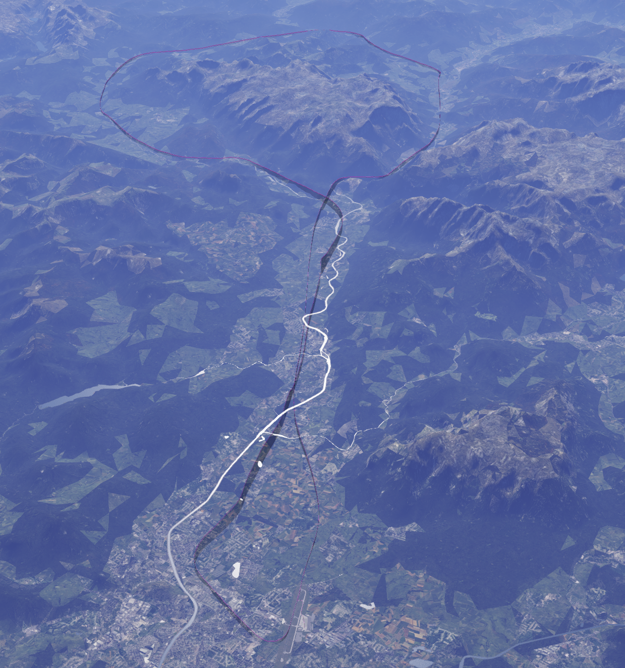 Vista cenital desde gran altura del valle del Salzach: la traza del vuelo dibujada sobre el terreno sube por el valle desde el aeropuerto y forma un lazo cerrado sobre el macizo montañoso del fondo.